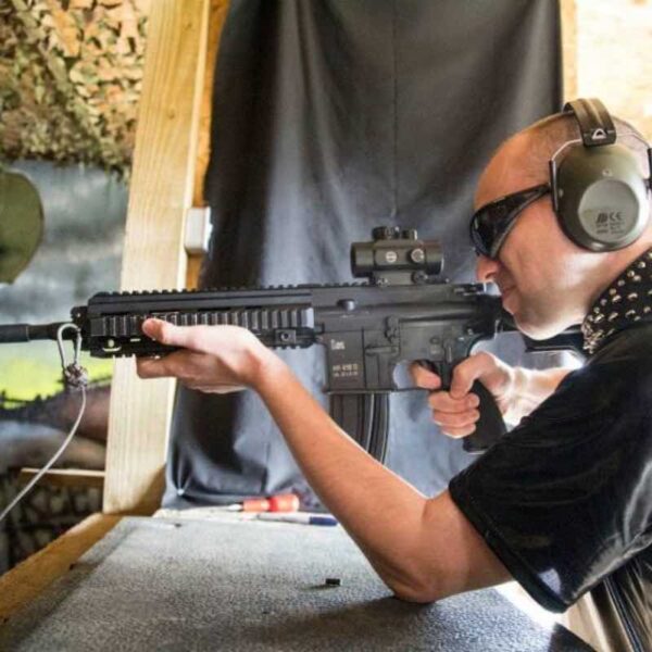 A man Assault Rifle Shooting wearing safety glasses