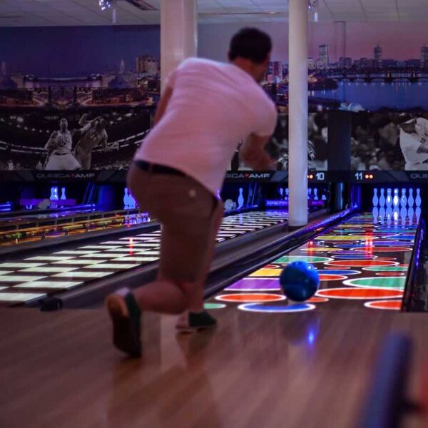 A man bowling a ball down a lane on a gift experience day