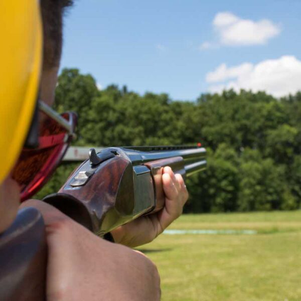 A POV of a man aiming down the barrel of a gun ready to shoot a Clay Pigeon