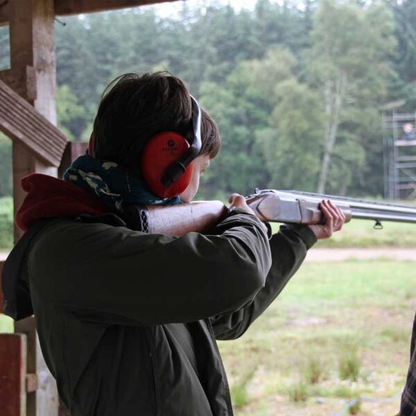 A woman aiming her gun for Clay Pigeon Shooting