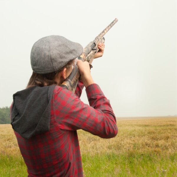 A person Clay Pigeon Shooting aiming their gun towards the sky