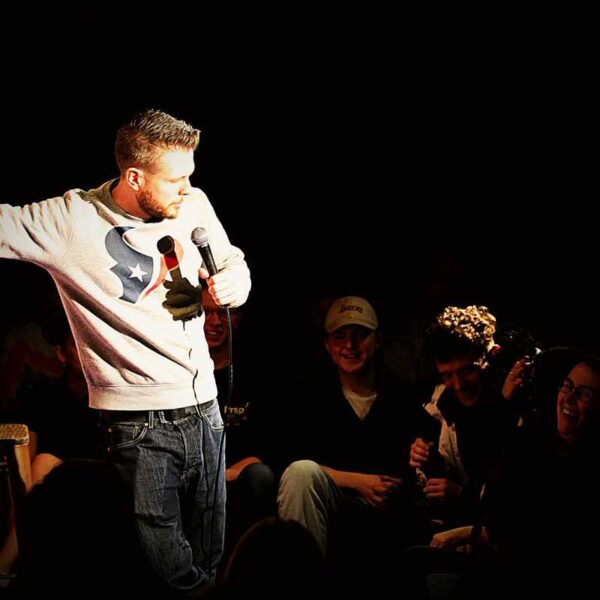 A comedian speaking to a crowd at a Comedy Club