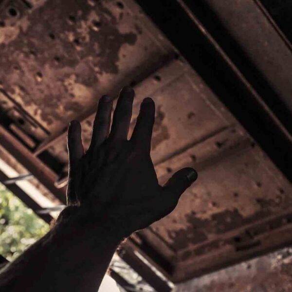 An ominous hand reaching out from below trying to Escape a Room