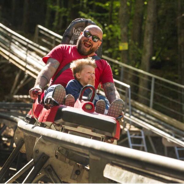 A man and his son on the Forest Coaster