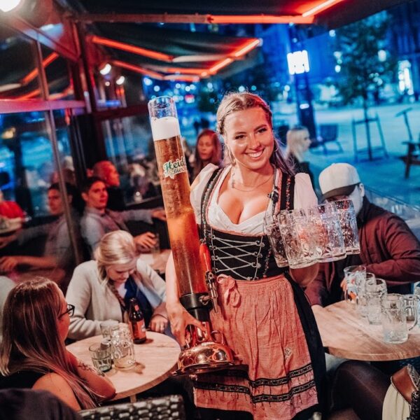 A Heidi's Bier Bar waitress carrying drinks for a Late Night Table Package