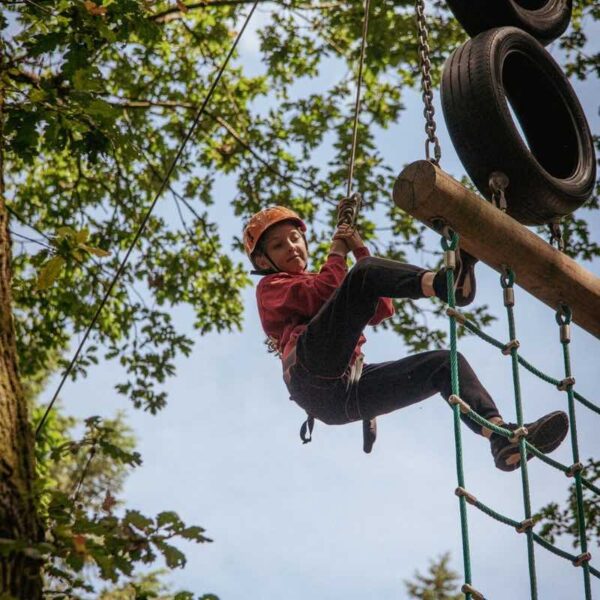 A girl climbing the High Ropes course