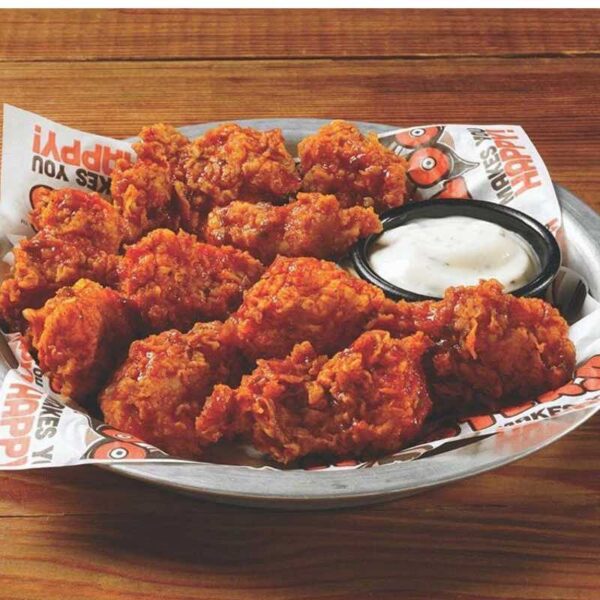 A close up of Hooters Party Meal chicken wings with dip
