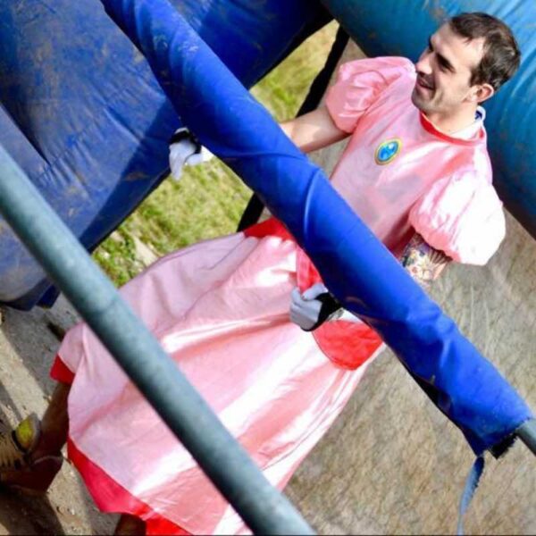 A man in a pink dress playing Human Table Football