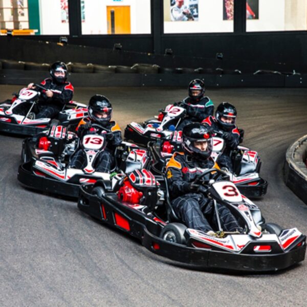 A group racing for their Indoor Karting Open Team Ultimate Race
