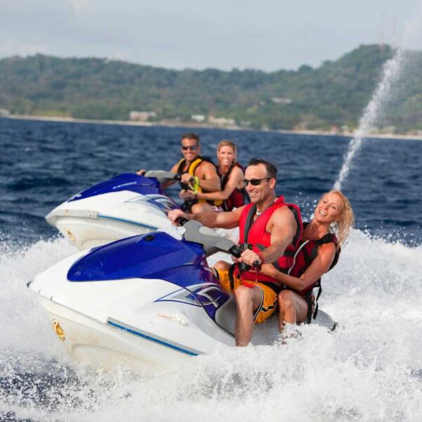Two couples on Jet Ski Safaris in the ocean riding the waves