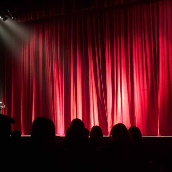 Just The Tonic Comedy Club stage and red curtain with a crowd on a Gift Experience Day