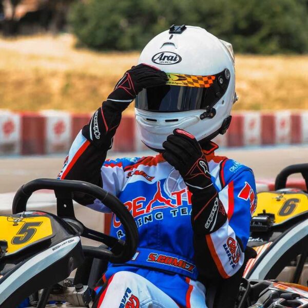 A woman dressed in a helmet and jumpsuit sat in an Outdoor Race Kart