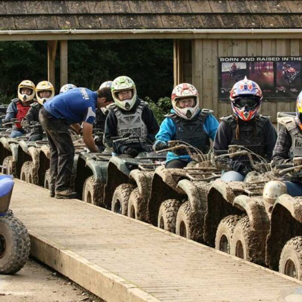 A group lined up in helmets Quad Biking