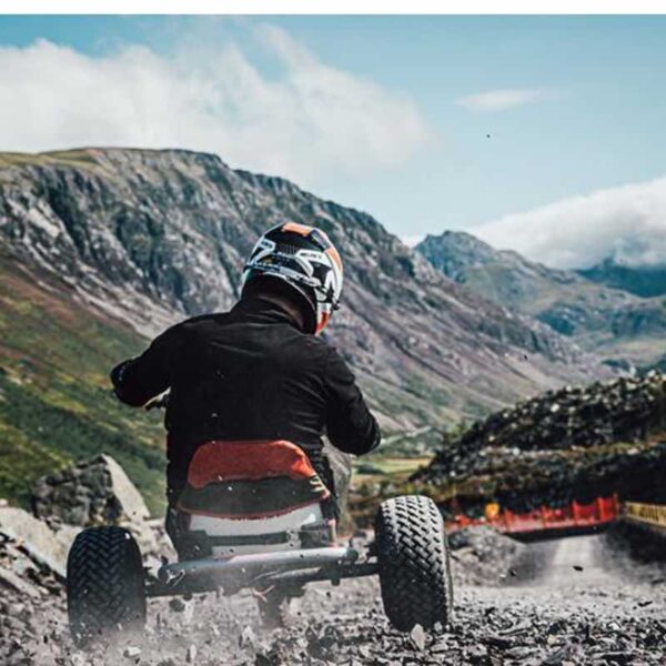 The back of a person Quarry Karting down a hill