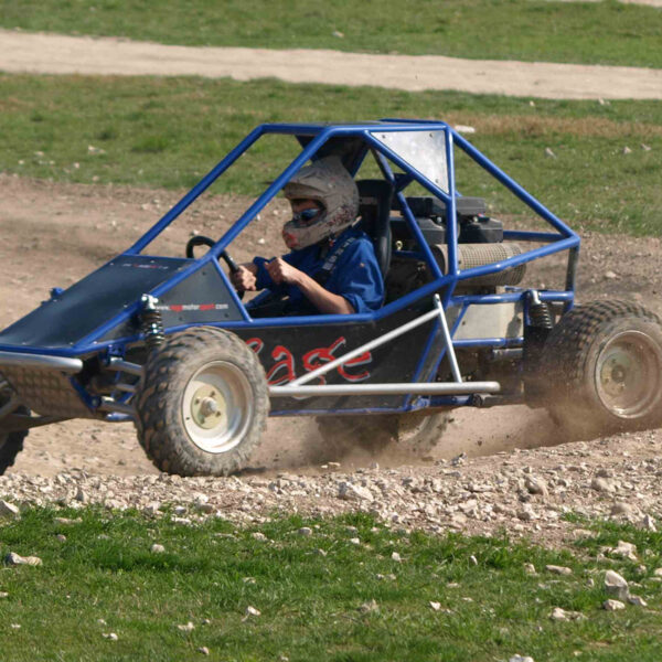 Blue rage buggy being raced around a track on a gift experience day