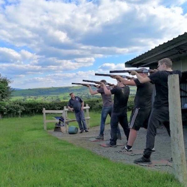 4 men lined up aiming for their Laser Clay Pigeon Shooting Gift Experience Day