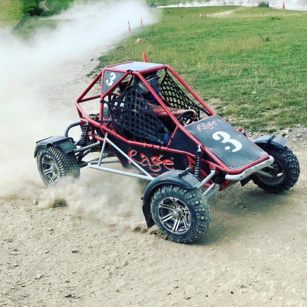 A man kicking up dust in a Rage Buggy on a Rage Combo activity day