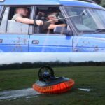 A man sliding across a field in a Hovercraft and a group Blindfold Driving in a car for a Reading Combo activity day