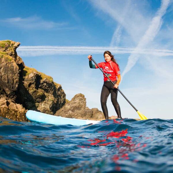 A lady Stand Up Paddleboarding in the ocean