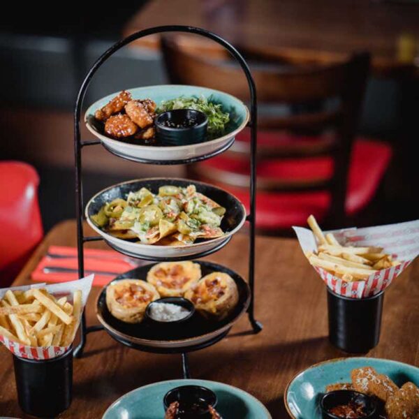 A table with fries and Brunch dishes in a tiered stand