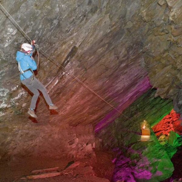 An action shot of a woman in the Zip Wire Caverns on a Gift Experience Day