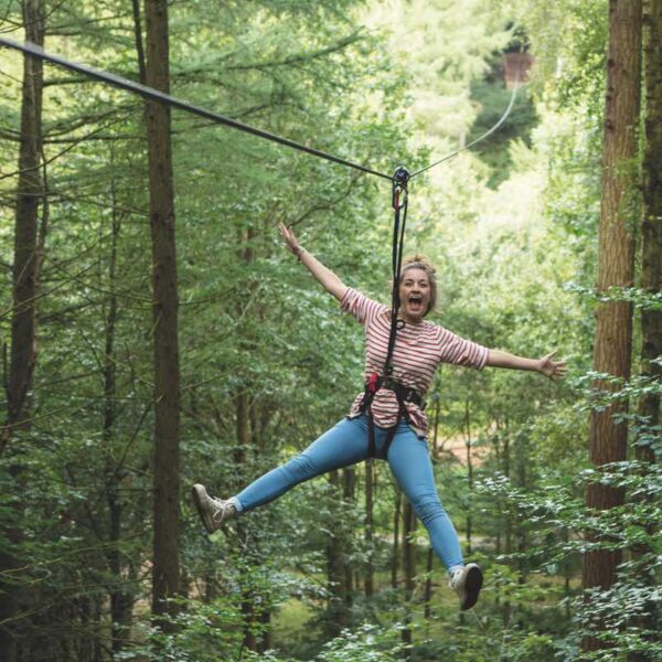 A woman flying through the air on the Zip Wire Safari