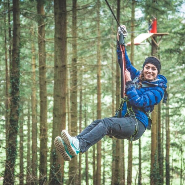 A woman on a zipline on the Zip Wire Safari course