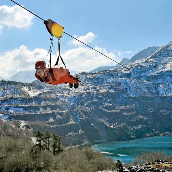 A man flying through the air on the Zip Wire Velocity