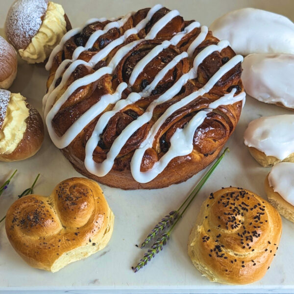 Close up of iced buns and various breads made in a Baking Masterclass
